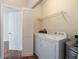 Bright laundry room features a washer, a dryer, and storage shelves at 9117 Lee Vista Blvd # 603, Orlando, FL 32829