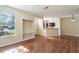 Open-concept living space with wood floors, a closet, and a view into the adjacent kitchen at 9117 Lee Vista Blvd # 603, Orlando, FL 32829