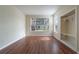 Bright living room featuring beautiful hardwood floors, large windows, and a closet for storage at 9117 Lee Vista Blvd # 603, Orlando, FL 32829