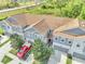 Aerial view of the community highlights neutral siding, tile roofs, two-car garages, and lush landscaping at 9161 Shepton St, Orlando, FL 32825