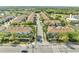 Aerial view featuring a community neighborhood entry street, townhomes and beautiful mature landscaping at 9161 Shepton St, Orlando, FL 32825
