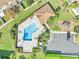 Aerial view of community pool, landscaping, a playground, ample parking and surrounding townhomes at 9161 Shepton St, Orlando, FL 32825