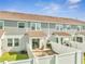 Backyard patio view with privacy fence, sliding glass doors and view of the townhome exterior at 9161 Shepton St, Orlando, FL 32825