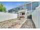 Fenced backyard features brick flooring, white fencing, and access to the building's rear entrance at 9161 Shepton St, Orlando, FL 32825