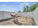 Fenced backyard with brick flooring features a grill with a white fence in the background at 9161 Shepton St, Orlando, FL 32825