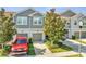 Charming townhome features a well-maintained front yard, gray siding, and attached garage in a desirable neighborhood at 9161 Shepton St, Orlando, FL 32825
