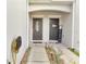 Inviting front entryway with dual doors, manicured landscaping, and a well-lit walkway at 9161 Shepton St, Orlando, FL 32825