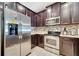 Modern kitchen showcasing stainless steel appliances and dark wood cabinetry at 9161 Shepton St, Orlando, FL 32825
