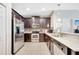 Kitchen with stainless steel appliances, dark wood cabinets, and tile backsplash at 9161 Shepton St, Orlando, FL 32825