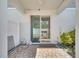 Covered patio with brick flooring features a sliding glass door with a grill visible inside at 9161 Shepton St, Orlando, FL 32825