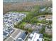 Community aerial view featuring mature trees, ponds, landscaping, and residential homes at 936 Wild Date Ln, Lake Mary, FL 32746