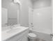 This full bathroom features a shower and tub combo with white tile, and a vanity with ample counter space at 936 Wild Date Ln, Lake Mary, FL 32746