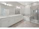 This bathroom features a double vanity, soaking tub, and glass shower enclosure at 936 Wild Date Ln, Lake Mary, FL 32746