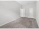 This bedroom has carpeted floors, neutral paint, base trim, and two entry doors at 936 Wild Date Ln, Lake Mary, FL 32746