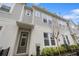Stylish townhome exterior with light-colored siding, well-manicured landscaping, and a welcoming front entrance under a covered porch at 936 Wild Date Ln, Lake Mary, FL 32746