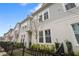 Charming townhomes with grey siding and white trim feature neat landscaping and black metal fences at 936 Wild Date Ln, Lake Mary, FL 32746
