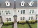 Charming two-story townhome featuring a landscaped front yard, inviting entrance, and dormer windows for added natural light at 936 Wild Date Ln, Lake Mary, FL 32746