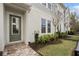 Inviting townhome entrance with a brick walkway, well-kept lawn, and attractive landscaping leading to a stylish front door at 936 Wild Date Ln, Lake Mary, FL 32746