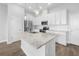 Bright kitchen featuring stainless steel appliances, white cabinets, granite countertops, and a central island for cooking and entertaining at 936 Wild Date Ln, Lake Mary, FL 32746
