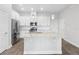 Modern kitchen with white cabinetry, stainless steel appliances, granite countertops, and a functional island for food preparation at 936 Wild Date Ln, Lake Mary, FL 32746