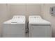 Bright laundry room features a side-by-side washer and dryer for easy convenience at 936 Wild Date Ln, Lake Mary, FL 32746