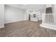 This large living room features wood-look floors, stairs, and an open floor plan into the kitchen at 936 Wild Date Ln, Lake Mary, FL 32746