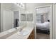 Well-lit bathroom vanity area that provides a sneak peek into an adjoining bedroom at 104 Wilton Cir, Sanford, FL 32773