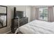 Bedroom view showcasing a large window and a dresser with a television on top at 104 Wilton Cir, Sanford, FL 32773