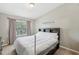 Cozy bedroom with large window and neutral color palette at 104 Wilton Cir, Sanford, FL 32773