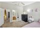 Bright bedroom featuring unicorn wall art, ensuite bathroom, and a ceiling fan at 104 Wilton Cir, Sanford, FL 32773