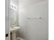 Powder room with a pedestal sink, round mirror, and neutral paint at 104 Wilton Cir, Sanford, FL 32773