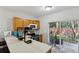 Well-lit kitchen featuring a breakfast bar, sliding glass doors to the patio, and modern appliances at 104 Wilton Cir, Sanford, FL 32773