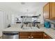 Bright kitchen with stainless steel appliances, a view to the living room, and ample counter space at 104 Wilton Cir, Sanford, FL 32773