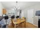Open kitchen and dining area with hardwood floors, a breakfast bar, and stainless steel appliances at 104 Wilton Cir, Sanford, FL 32773
