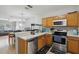 Efficient kitchen featuring stainless steel appliances, wooden cabinetry, and an open layout at 104 Wilton Cir, Sanford, FL 32773