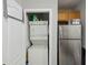 Efficient laundry area featuring stacked washer and dryer, plus a stainless steel refrigerator at 104 Wilton Cir, Sanford, FL 32773