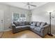 Comfortable living room with a large sectional sofa, neutral walls, and a bright window at 104 Wilton Cir, Sanford, FL 32773