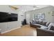 Spacious living area with a large TV, a comfortable sofa, and a view of the front entry at 104 Wilton Cir, Sanford, FL 32773