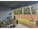 The patio has outdoor seating, potted plants and a view of the grassy backyard and brick wall at 104 Wilton Cir, Sanford, FL 32773