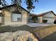 Low angle view of single-story home with a two-car garage and well-maintained landscaping at 117 Anzio Dr, Kissimmee, FL 34758
