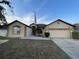Charming single-story home with a two-car garage and well-maintained landscaping at 117 Anzio Dr, Kissimmee, FL 34758