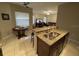 Kitchen island with stainless steel sink overlooking open living area at 117 Anzio Dr, Kissimmee, FL 34758