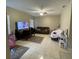 Cozy room with neutral walls, tile floor, and ample room for relaxing and playing at 117 Anzio Dr, Kissimmee, FL 34758