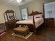 Spacious bedroom with an elegant, four-poster bed and matching furniture at 117 Anzio Dr, Kissimmee, FL 34758