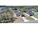 Aerial view of modern house with a dark roof, long driveway, and backyard at 13584 Sw 43Rd Cir, Ocala, FL 34473