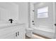 Modern bathroom with white cabinets, sleek fixtures, and a window in the shower at 13584 Sw 43Rd Cir, Ocala, FL 34473