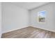 Bright bedroom with wood-look flooring, white trim, and ample natural light at 13584 Sw 43Rd Cir, Ocala, FL 34473