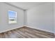 Bright bedroom featuring wood-look flooring and a view of the outside at 13584 Sw 43Rd Cir, Ocala, FL 34473