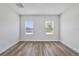 A bright bedroom boasts two windows and neutral walls, offering a serene retreat at 13584 Sw 43Rd Cir, Ocala, FL 34473