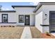 Close-up view of a modern home featuring black trim and a well-maintained walkway at 13584 Sw 43Rd Cir, Ocala, FL 34473